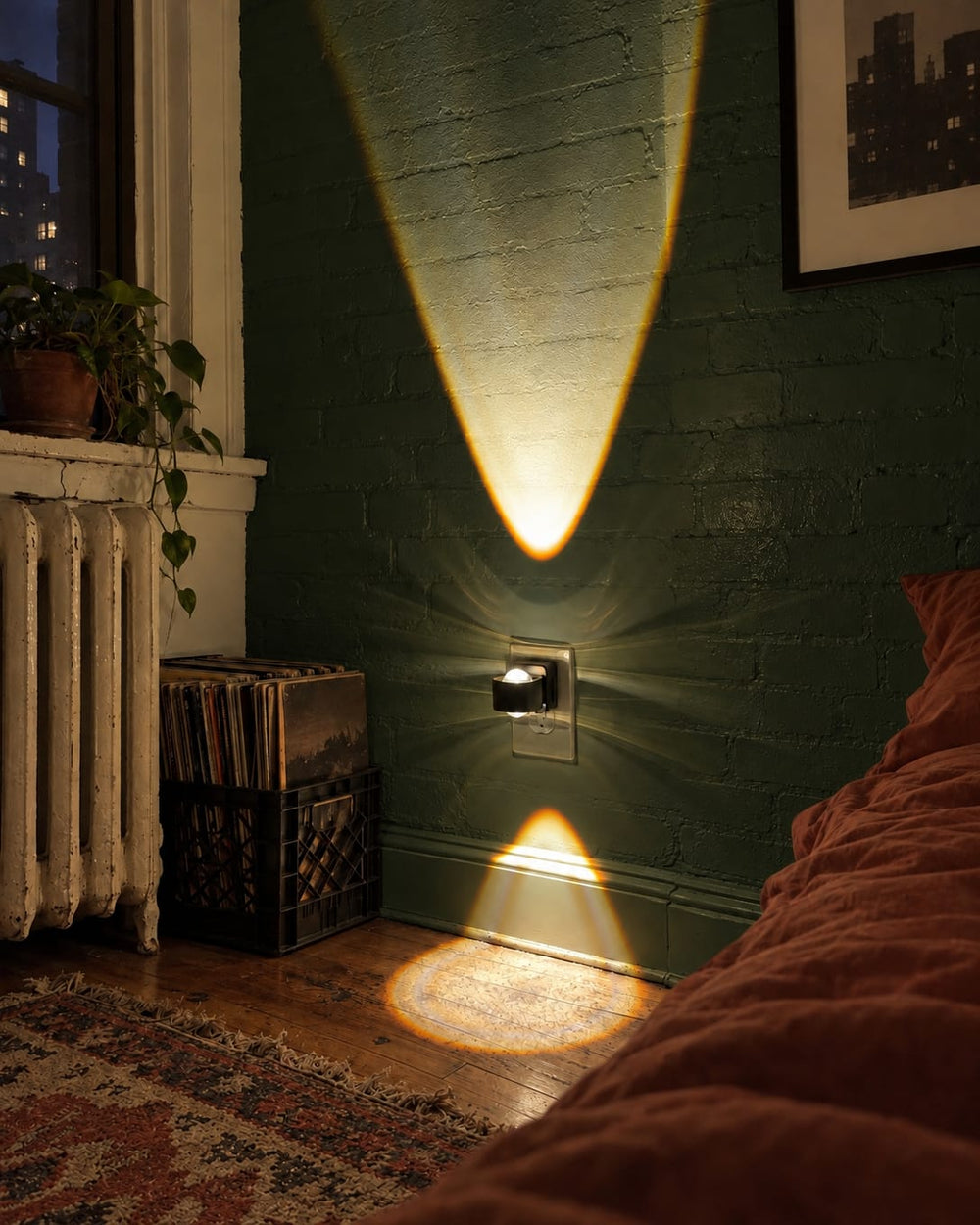 Aoraglow glowing on the wall beside the bed in a Brooklyn walk-up bedroom at night, warm and cozy