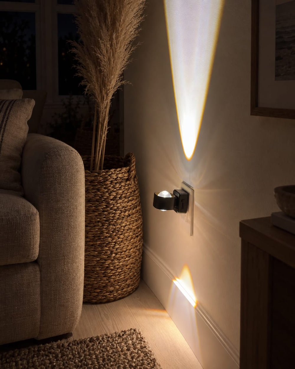 Aoraglow glowing warm on the wall of a coastal living room at night, the room soft and dim around it