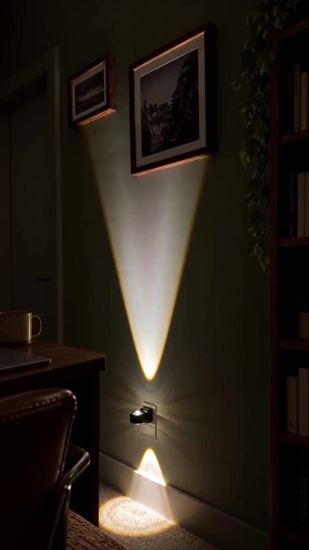 Aoraglow glowing warm up and down a living room wall at night, the room cozy and dim, nobody in frame, a calm still camera